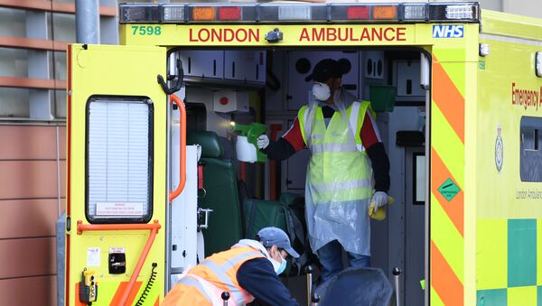 Staff wearing personal protective equipment (PPE) disinfect a London Ambulance outside The Royal London Hospital in east London on April 19, 2020.  - Sputnik International