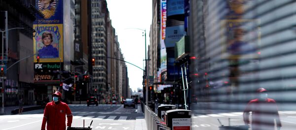 A Times Square Alliance street sweeper worker walks though a nearly empty Times Square in Manhattan during the outbreak of the coronavirus disease (COVID-19) in New York City, New York, U.S., April 7, 2020 - Sputnik International