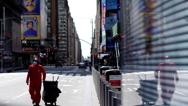 A Times Square Alliance street sweeper worker walks though a nearly empty Times Square in Manhattan during the outbreak of the coronavirus disease (COVID-19) in New York City, New York, U.S., April 7, 2020 - Sputnik International