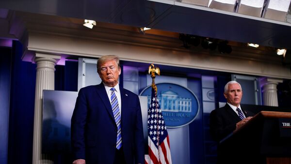 U.S. President Donald Trump signals FDA Commissioner Dr. Stephen Hahn (not pictured) as U.S. Vice President Mike Pence speaks during the daily coronavirus task force briefing at the White House in Washington, U.S., April 19, 2020 - Sputnik International