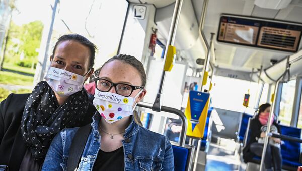 Commuters wear protective face masks while riding a tram in the east German city of Leipzig on April 20, 2020, amid the novel coronavirus COVID-19 pandemic. - Sputnik International