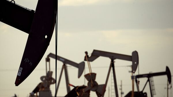 In this April 24, 2015 file photo, pumpjacks work in a field near Lovington, N.M. The United States may have reclaimed the title of the world's biggest oil producer sooner than expected - Sputnik International