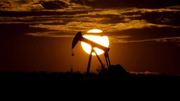 The sun sets behind an idle pump jack near Karnes City, Texas, Wednesday, April 8, 2020. Demand for oil continues to fall due to the new coronavirus outbreak - Sputnik International