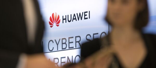Two people look at their cellphones in front of the Huawei logo during a DigitALL lunch talk in Brussels, Tuesday, May 21, 2019 Two people look at their cellphones in front of the Huawei logo during a DigitALL lunch talk in Brussels, Tuesday, May 21, 2019 - Sputnik International