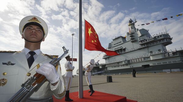 In this photo taken Dec. 17, 2019 and released Dec. 27, 2019 by Xinhua News Agency, Chinese honor guard raise the Chinese flag during the commissioning ceremony of China's Shandong aircraft carrier at a naval port in Sanya, south China's Hainan Province - Sputnik International