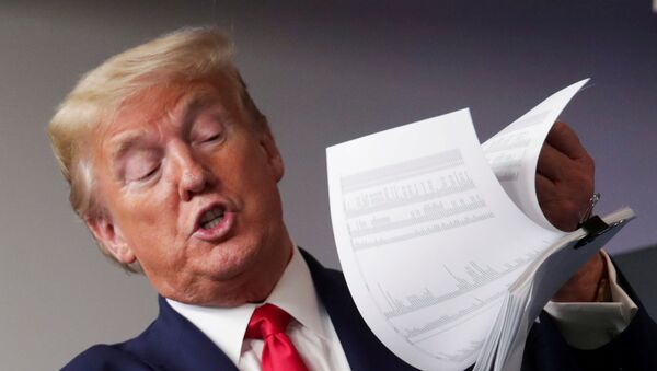 U.S. President Donald Trump holds up a list of coronavirus testing locations that he says U.S. states can use as he addresses the daily coronavirus task force briefing at the White House in Washington, U.S., April 20, 2020 - Sputnik International