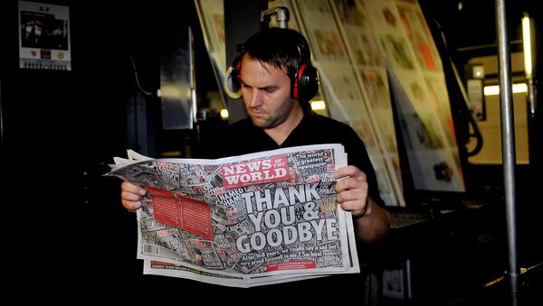A printer checks the last copy of the News of the World as it rolls off the presses in 2011 - Sputnik International
