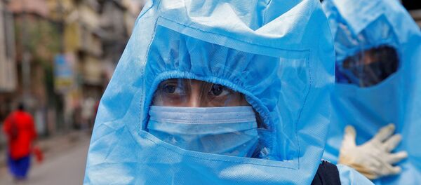 Indian health workers wearing protective gear check people to find out if they have developed any COVID-19 symptoms - Sputnik International