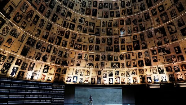 A security personnel walks at the Hall of Names at the Yad Vashem World Holocaust Remembrance Center in Jerusalem, before beginning of Israel's annual Holocaust Remembrance Day, as the centre is closed following the coronavirus disease (COVID-19) restrictions around the country, April 20, 2020 - Sputnik International