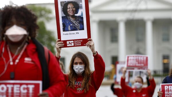 Nurses from National Nurses United protest in front of the White House, Tuesday, April 21, 2020, in Washington, while social distancing. The group sought to bring attention to health care workers across the country who have contracted COVID-19 due to a lack of personal protective equipment.  - Sputnik International