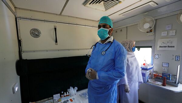 A doctor and nurse wear protective masks as they stand in a passenger train's car, after the government turned it into a hospital and quarantine center following the outbreak of coronavirus disease (COVID-19), in Karachi, Pakistan, March 31, 2020 - Sputnik International