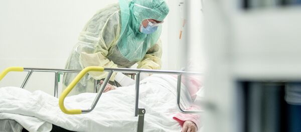 A nurse in protective gear takes a blood sample of a patient potentially infected with coronavirus disease (COVID-19) - Sputnik International