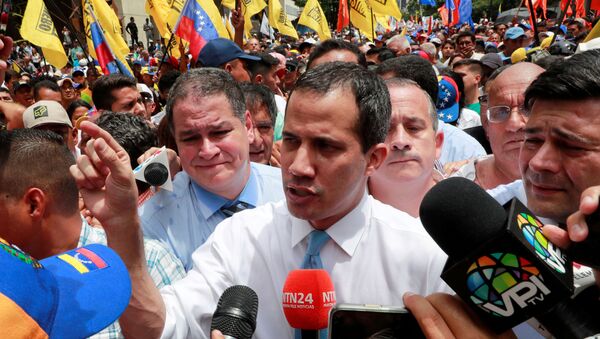 Venezuela's National Assembly President and opposition leader Juan Guaido, who many nations have recognised as the country's rightful interim ruler, talks to the media as he takes part in a demonstration in Caracas, Venezuela March 10, 2020 - Sputnik International