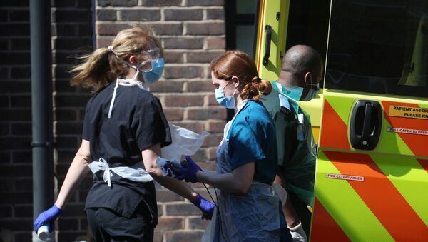 British Doctors with face mask outside of hospital next to ambulance - Sputnik International