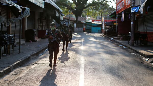Salvadoran soldiers patrol on a street during a military operation as part of security measures ordered by El Salvador's President Nayib Bukele to keep people inside their homes during a quarantine throughout the country to prevent the spread of the coronavirus disease (COVID-19), in La Libertad, El Salvador April 18, 2020 - Sputnik International