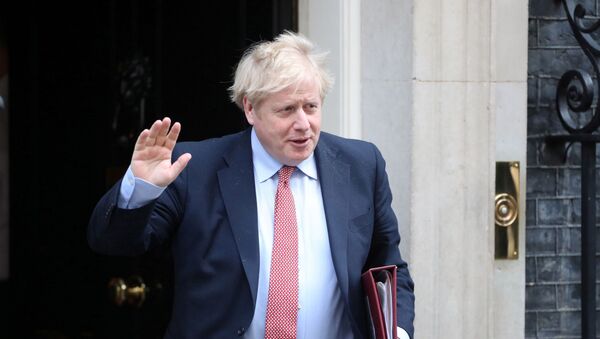 Britain's Prime Minister Boris Johnson waves as he leaves Downing Street, as the spread of coronavirus disease (COVID-19) continues. London, Britain, March 25, 2020. - Sputnik International