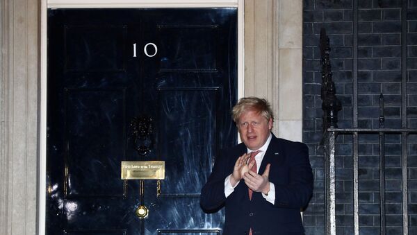 FILE PHOTO: Britain's Prime Minister Boris Johnson applauds outside 10 Downing Street during the Clap for our carers campaign in support of the NHS, as the spread of the coronavirus disease (COVID-19) continues, London, Britain, March 26, 2020.  - Sputnik International