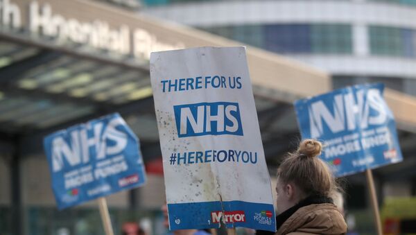 NHS signs are seen outside Queen Elizabeth Hospital during the Clap for our Carers campaign in support of the NHS, as the spread of the coronavirus disease (COVID-19) continues, in Birmingham, Britain, April 23, 2020.  - Sputnik International