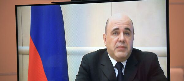 Russian Prime Minister Mikhail Mishustin (on monitor) during a video conference with Russian President Vladimir Putin. - Sputnik International
