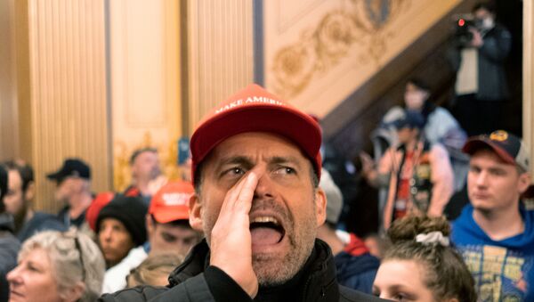  protester yells at Michigan State Police after demonstrators occupied the state capitol building during a vote to approve the extension of Governor Gretchen Whitmer's emergency declaration/stay-at-home order due to the coronavirus disease (COVID-19) outbreak, at the state capitol in Lansing, Michigan, U.S. April 30, 2020 - Sputnik International