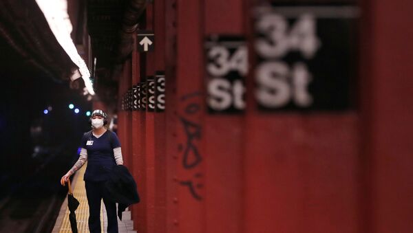 A woman wears a mask while waiting to ride the New York City Subway as the outbreak of the coronavirus disease (COVID-19) continues in the Manhattan borough of New York, U.S., April 30, 2020 - Sputnik International