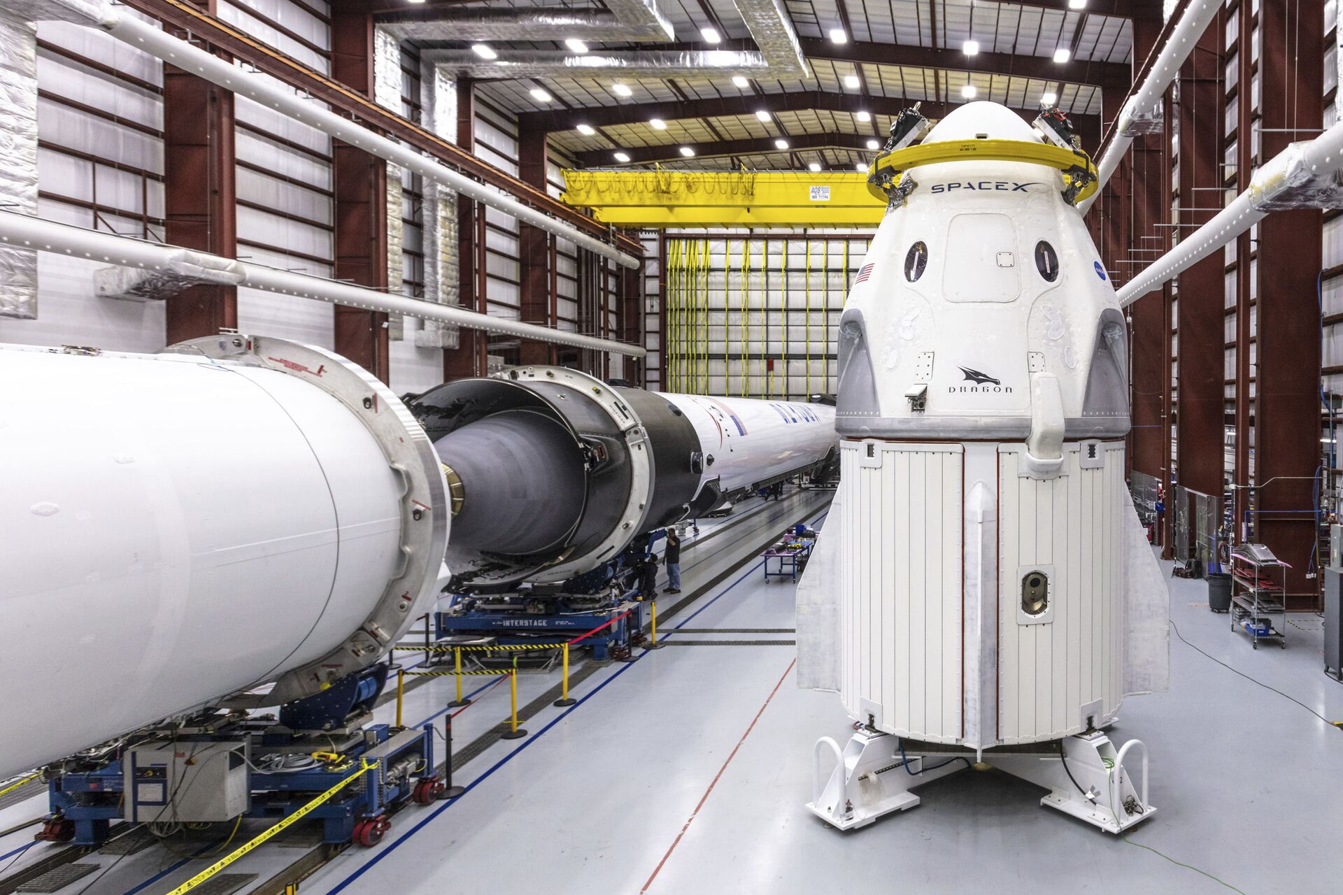 In this Dec. 18, 2018 photo provided by SpaceX, SpaceX's Crew Dragon spacecraft and Falcon 9 rocket are positioned inside the company's hangar at Launch Complex 39A at NASA's Kennedy Space Center in Florida, ahead of the Demo-1 unmanned flight test - Sputnik International, 1920, 26.10.2021
