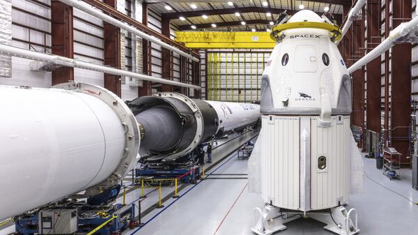 In this Dec. 18, 2018 photo provided by SpaceX, SpaceX's Crew Dragon spacecraft and Falcon 9 rocket are positioned inside the company's hangar at Launch Complex 39A at NASA's Kennedy Space Center in Florida, ahead of the Demo-1 unmanned flight test - Sputnik International