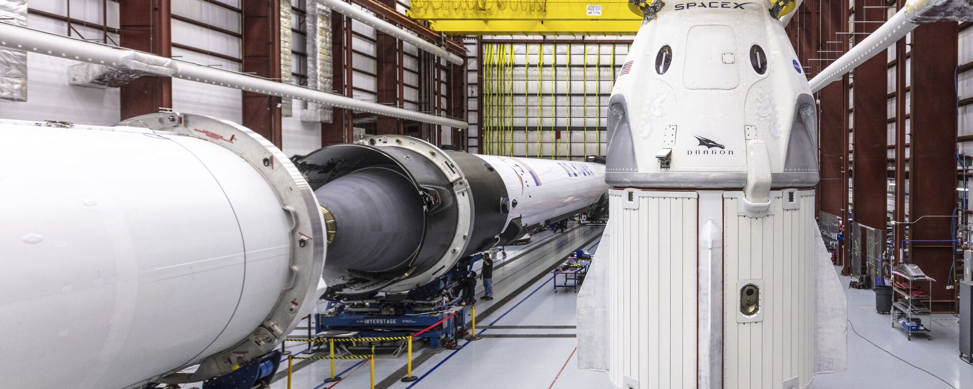 In this Dec. 18, 2018 photo provided by SpaceX, SpaceX's Crew Dragon spacecraft and Falcon 9 rocket are positioned inside the company's hangar at Launch Complex 39A at NASA's Kennedy Space Center in Florida, ahead of the Demo-1 unmanned flight test - Sputnik International, 1920, 11.11.2020