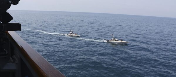 In this Wednesday, April 15, 2020, photo made available by U.S. Navy, Iranian Revolutionary Guard vessels sail close to U.S. military ships in the Persian Gulf near Kuwait In this Wednesday, April 15, 2020, photo made available by U.S. Navy, Iranian Revolutionary Guard vessels sail close to U.S. military ships in the Persian Gulf near Kuwait - Sputnik International