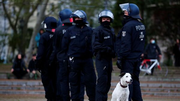 Police officers gather next to a dog during a demonstration on May Day, amid the spread of the coronavirus disease (COVID-19), in Berlin, Germany May 1, 2020 - Sputnik International