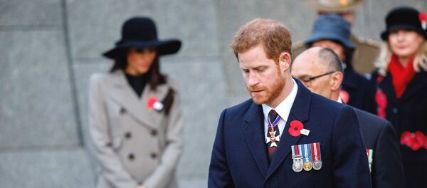 Britain's Prince Harry and his fiancee Meghan Markle, background attend an Anzac Day dawn service, at Hyde Park Corner in London, Wednesday, 25 April 2018. ANZAC Day commemorates the moment when Australian and New Zealand Army Corps troops landed at the Gallipoli peninsula in Turkey in what was to become the largest military defeat in either country's history. - Sputnik International
