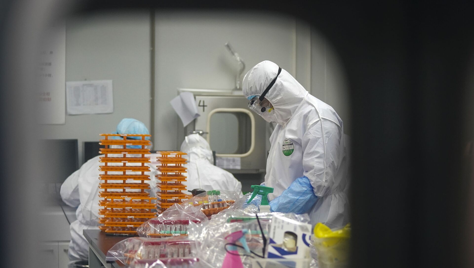 This Saturday, Feb. 22, 2020, photo released by Xinhua News Agency, shows medical workers in protective suits at a coronavirus detection lab in Wuhan in central China's Hubei Province. The fresh national figures for the disease that emerged in China in December came as the number of viral infections soared mostly in and around the southeastern city of Daegu, where they were linked to a local church and a hospital. - Sputnik International, 1920, 06.08.2021