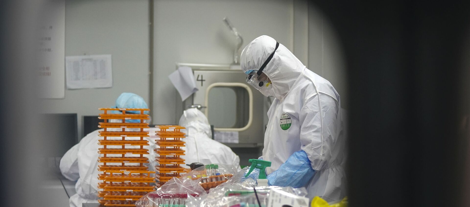 This Saturday, Feb. 22, 2020, photo released by Xinhua News Agency, shows medical workers in protective suits at a coronavirus detection lab in Wuhan in central China's Hubei Province. The fresh national figures for the disease that emerged in China in December came as the number of viral infections soared mostly in and around the southeastern city of Daegu, where they were linked to a local church and a hospital. - Sputnik International, 1920