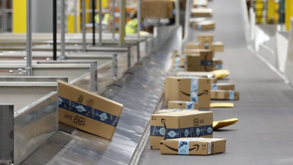 In this Dec. 17, 2019, file photo, Amazon packages move along a conveyor at an Amazon warehouse facility in Goodyear, Ariz. Amazon will report quarterly earnings on Thursday, APril 30, 2020, providing a first glimpse into its financial performance during the pandemic - Sputnik International