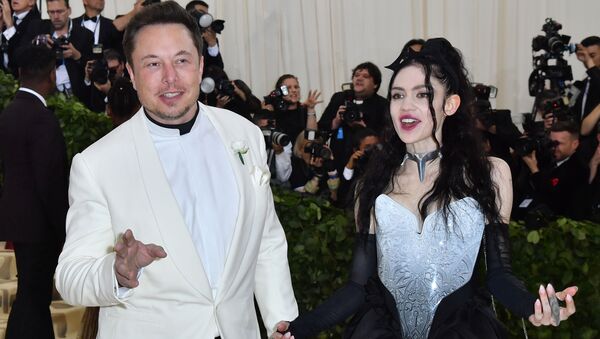 (FILES) In this file photo taken on 7 May 2018 Elon Musk and Grimes arrive for the 2018 Met Gala, at the Metropolitan Museum of Art in New York. - Elon Musk's girlfriend has given birth to the couple's first child together, the outspoken Tesla chief announced on May 4, 2020. Musk, 48, has been dating the musician Grimes since 2018.  - Sputnik International