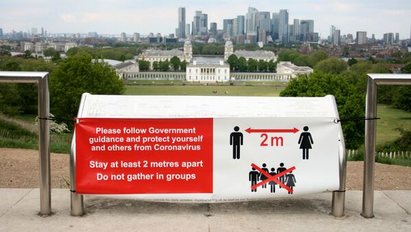 A sign is seen telling people to socially distance in Greenwich Park, following the outbreak of the coronavirus disease (COVID-19), London, Britain, May 4, 2020 - Sputnik International