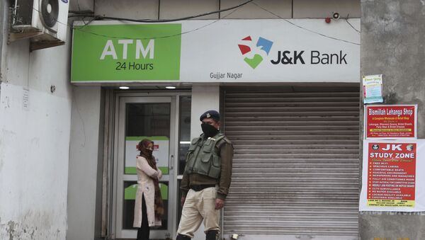 A security person stands guard outside an ATM during lockdown to prevent the spread of new coronavirus in Jammu, India, Tuesday, March 31, 2020 - Sputnik International