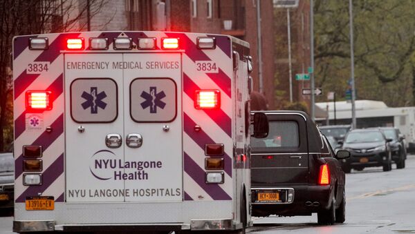 An ambulance escorts the hearse carrying the casket of New York City paramedic Anthony Tony Thomas following his funeral during the outbreak - Sputnik International