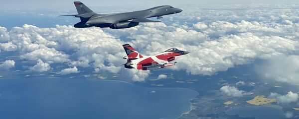 A B-1B Lancer flies with a Danish F-16 during a training mission for Bomber Task Force Europe, May 5, 2020. A B-1B Lancer flies with a Danish F-16 during a training mission for Bomber Task Force Europe, May 5, 2020. - Sputnik International