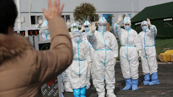 FILE PHOTO: Medical personnel in protective suits wave hands to a patient who is discharged from the Leishenshan Hospital after recovering from the novel coronavirus, in Wuhan, the epicentre of the novel coronavirus outbreak, in Hubei province, China March 1, 2020 - Sputnik International