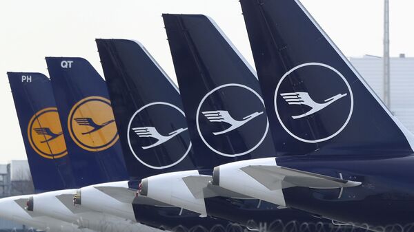 German Lufthansa planes sit parked in a line at the airport in Munich, Germany, Thursday, March 26, 2020 - Sputnik International