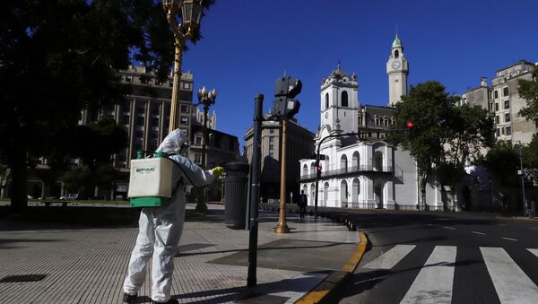 A worker disinfects Plaza de Mayo after Argentina's President Alberto Fernandez announced a mandatory quarantine as a measure to curb the spread of coronavirus disease (COVID-19), in Buenos Aires, Argentina March 20, 2020 - Sputnik International