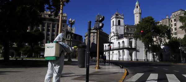 A worker disinfects Plaza de Mayo after Argentina's President Alberto Fernandez announced a mandatory quarantine as a measure to curb the spread of coronavirus disease (COVID-19), in Buenos Aires, Argentina March 20, 2020 - Sputnik International