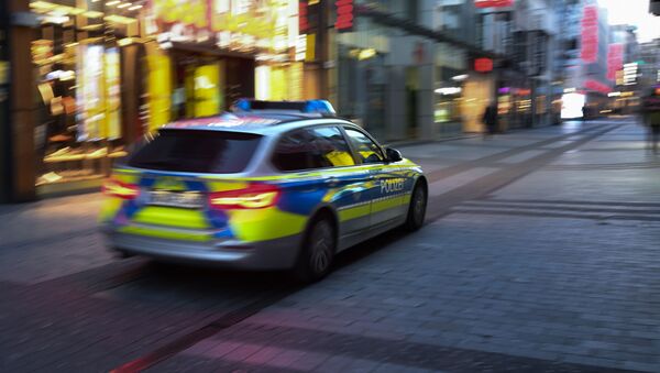 A police car drives through the pedestrian zone in Cologne, western Germany, on March 23, 2020 during the novel coronavirus COVID-19 pandemeic - Sputnik International