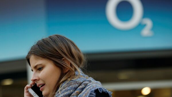 A woman speaks on a mobile telephone outside an O2 store in central London - Sputnik International