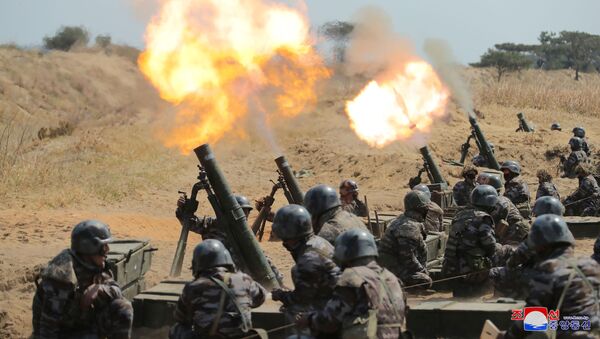 Mortar sub-units of North Korean Army fire as North Korean leader Kim Jong Un (not pictured) guides a drill in this image released by North Korea's Korean Central News Agency (KCNA) on April 10, 2020 - Sputnik International