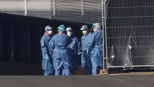 Medical staff are seen wearing PPE clothing outside the NHS Nightingale Hospital at the Excel Centre, London, Britain April 9, 2020 - Sputnik International