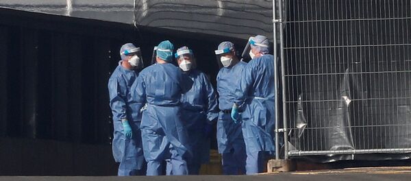 Medical staff are seen wearing PPE clothing outside the NHS Nightingale Hospital at the Excel Centre, London, Britain April 9, 2020 - Sputnik International