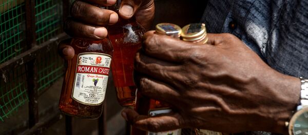 A man carries bottles of alcohol bought from a liquor shop after the government eased a nationwide lockdown imposed as a preventive measure against the COVID-19 coronavirus, on the outskirts of Chennai on May 7, 2020.  - Sputnik International