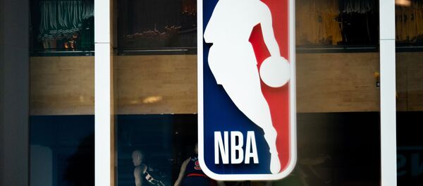  In this file photo taken on March 11, 2020 an NBA logo is shown at the 5th Avenue NBA store in New York City.   BasketNBAhealthvirustests - The NBA has advised teams not to arrange coronavirus tests for players and staff not showing symptoms, ESPN reported on May 1, 2020, saying it was inappropriate with only limited public testing available. - Sputnik International